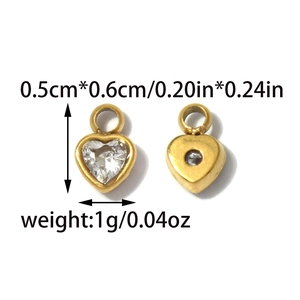 Macro view of gold heart pendants with clear zircon stones and precise dimensions
