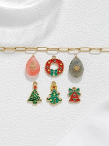 Detailed view of Christmas themed enamel charms with festive holiday patterns