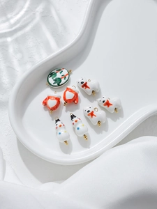 Macro view of handmade ceramic Christmas charms including snowmen and polar bears