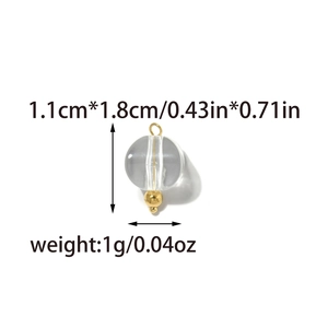 Detail view of a 1.1cm clear spherical glass pendant with a gold hook and weight details