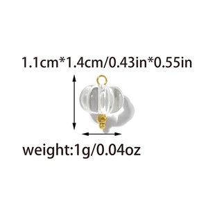 Detailed size view of pumpkin shaped glass pendant with gold hardware 1.1x1.4cm