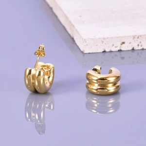 Macro view of 18K gold plated C-shape earrings with double-layered groove design