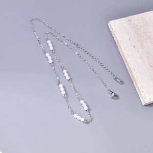 Detail van het K18-kenmerk op elegante roestvrijstalen parelketting met sluiting