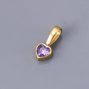 Detailed macro view of heart-shaped gold-plated pendant with purple cubic zirconia stone