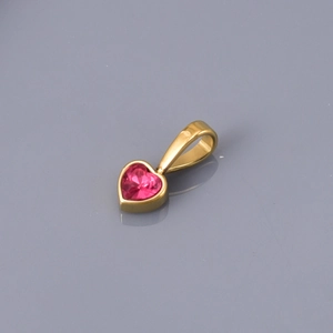 Close-up of heart-shaped pink gemstone pendant with gold-plated metal setting