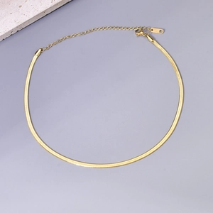 Detailed close-up of golden flat snake chain necklace with K18 engraving and lobster clasp
