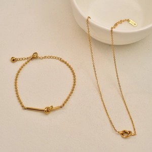 Gold-plated knot jewelry set featuring a bead bracelet and k18 engraved necklace