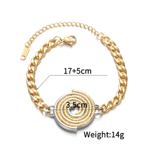 Detail of two-tone stainless steel bracelet featuring a 3.5cm spiral disk and S.STEEL tag