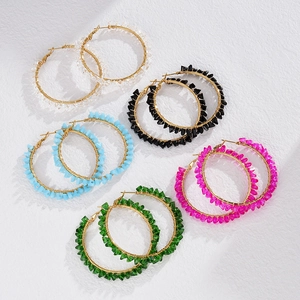 Five pairs of handmade crystal hoop earrings in assorted colors with gold wire wrapping
