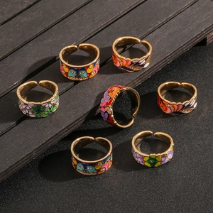 Set of 7 gold-plated 18k rings featuring colorful enamel flowers and cat designs