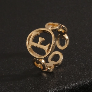 18K gold plated minimalist letter F ring with chain design on black background