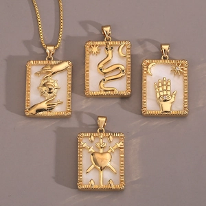 Macro shot of gold tarot pendants with shell inlay and mystical engraved symbols