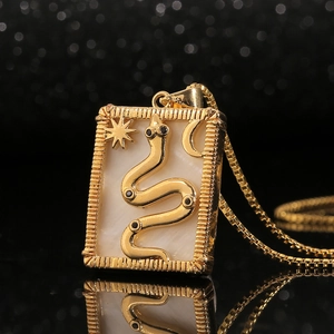 Golden box chain necklace featuring a rectangular shell pendant with a 3D snake and moon