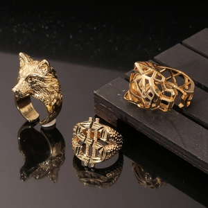 Detailed shot of gold animal rings featuring wolf, dollar sign, and geometric leopard head