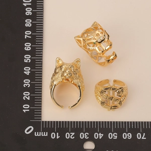 Detail view of hip hop gold rings set featuring leopard head, wolf head and dollar sign