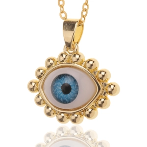 Evil Eye pendant necklace with blue iris and gold beaded frame on a golden chain