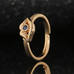 Adjustable gold ring with a round blue gemstone in a radiant sunburst setting