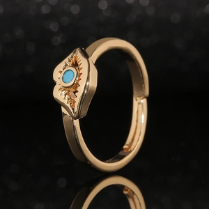 Adjustable golden lip-shaped ring featuring a turquoise stone in a boho sunburst design