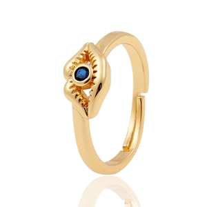 Adjustable gold ring with sunburst design and dark blue center stone on white surface