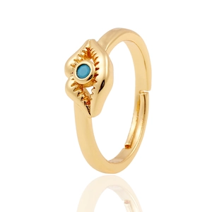 Detail of golden adjustable open ring featuring blue evil eye stone and metal carving