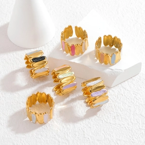 Detail of 18k gold plated stainless steel rings with colorful enamel wave patterns