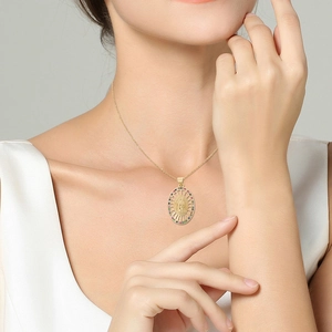 Religious necklace with Virgin Mary pendant and colorful zircons on a female model
