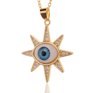 Evil eye sun necklace pendant in gold plating with blue inlay and shimmering crystals