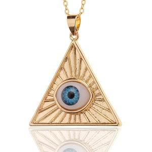Golden Evil Eye pendant with blue iris inlay and radiant rays on a polished link chain