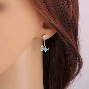 Charming gold-plated bear drop earrings with pink and blue crystal studs on model