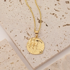 Close-up of vintage 18K gold plated necklace with 3D animal claw pendant on stone