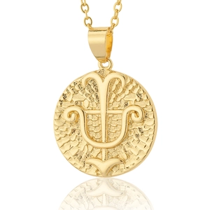 Detail of 18K gold plated zodiac coin necklace featuring embossed Greek symbol and hammered texture