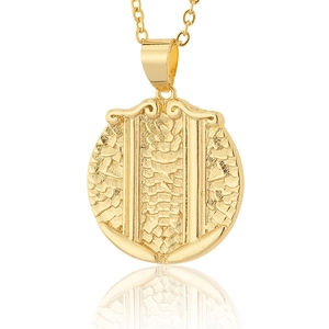 Detail of 18K gold plated shield pendant featuring embossed scales and vintage texture