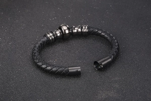 Detail of men's black braided leather bracelet with gunmetal beads and magnetic clasp