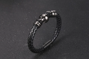 Detail of black woven leather bracelet with matte gunmetal beads and magnetic clasp