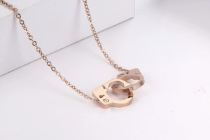 Detail of rose gold handcuff necklace with sparkling pavé crystals and O-chain