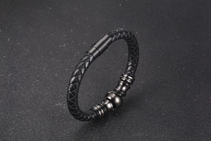 Detail of men's black braided leather bracelet with gunmetal magnetic clasp and steel rings