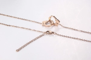 Detail of rose gold handcuff pendant with adjustable O-chain and lobster clasp closure