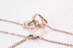 Detail of rose gold handcuff pendant necklace with lobster clasp and extension chain