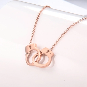 Minimalist rose gold titanium necklace featuring a stylish interlocking handcuffs pendant