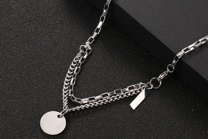 Detail of silver double-layer titanium steel necklace with round and rectangle pendants