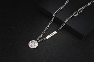 Detail of OT buckle necklace with engraved soul metal plate and coin pendant charms