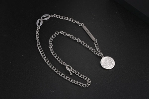 Macro shot of silver OT clasp necklace with round coin pendant and 'THE SOUL' engraving