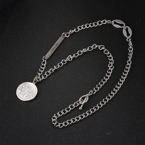 Silver coin pendant necklace with OT buckle and engraved soul bar on black background