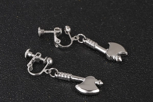Macro shot of silver axe pendant clip-on earrings with adjustable screw-back closure