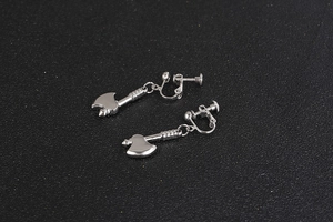 Detailed close-up of punk style silver axe earrings with screw-back clip-on mechanism