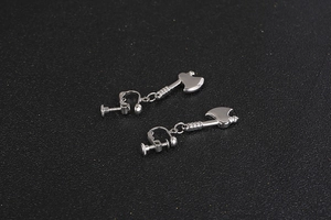 Detail view of silver axe-shaped clip-on earrings with adjustable screw-back closure