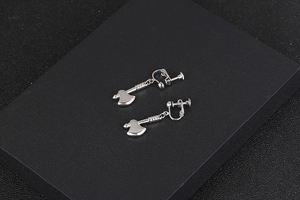 Macro detail of silver axe pendant earring showing polished finish and screw clip structure