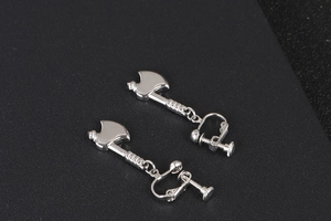 Macro shot of silver axe shaped earrings with adjustable screw back clips for women