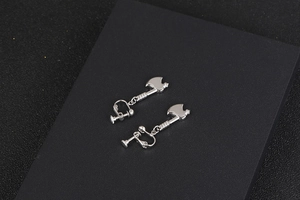 Detailed view of silver axe-shaped clip-on earrings with textured handle and polished finish