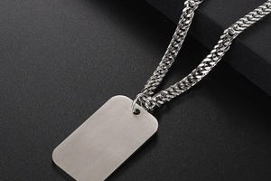 Detail of brushed titanium steel military dog tag necklace with polished Cuban chain
